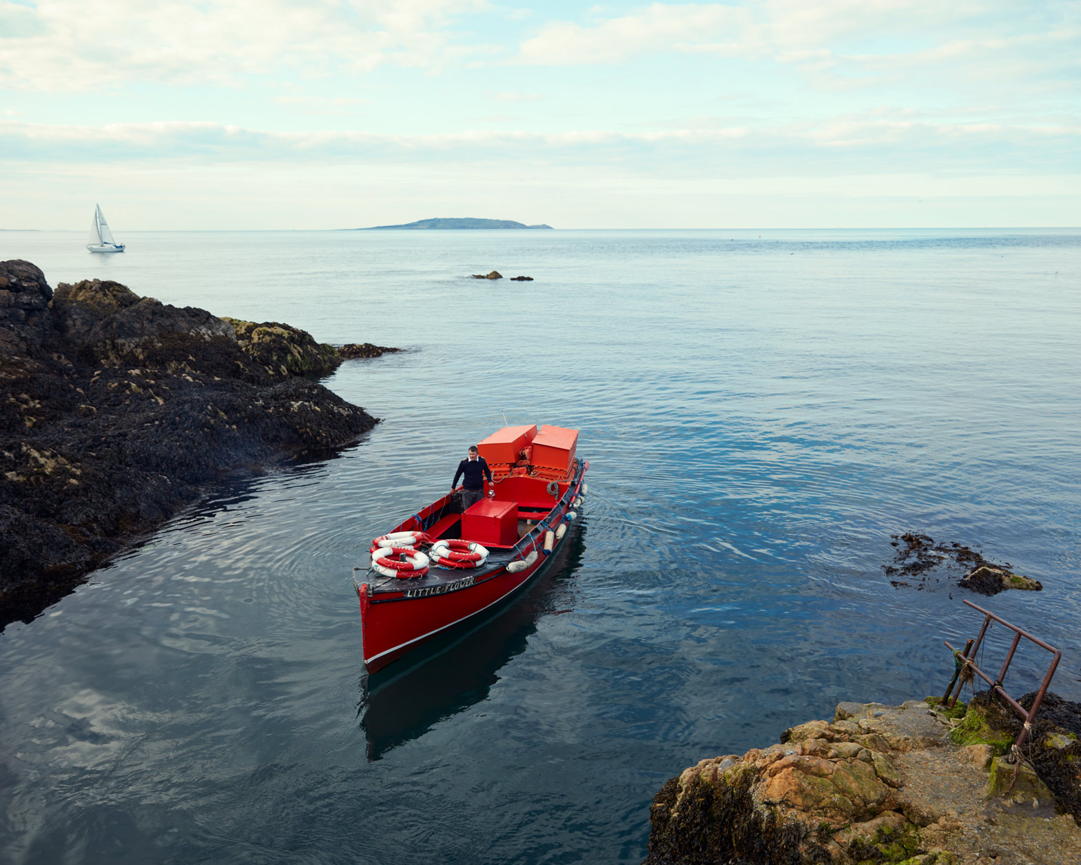 business photography: a fishing boat approaches harbour