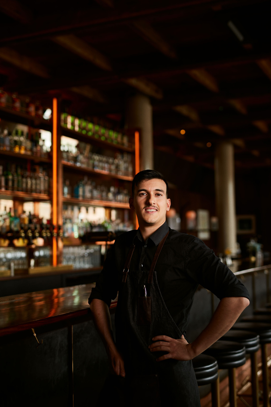 location portrait photography: waiter at bar