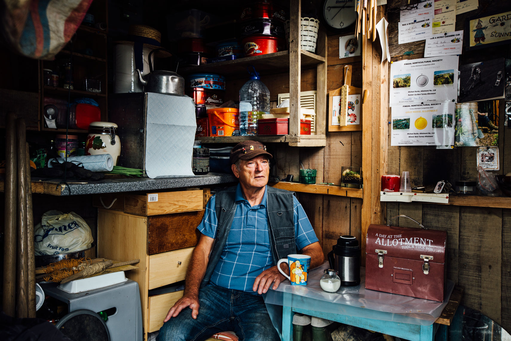 environmental photography: a gardener relaxes in  his shed 