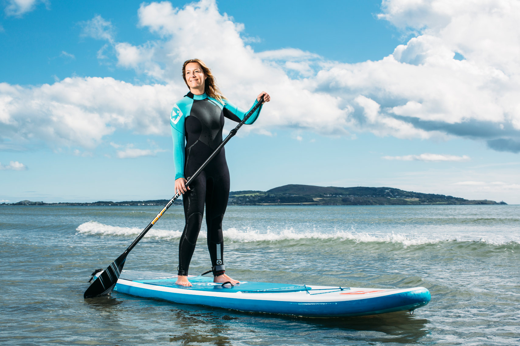 athlete portraits: paddleboarder paddles on sea 