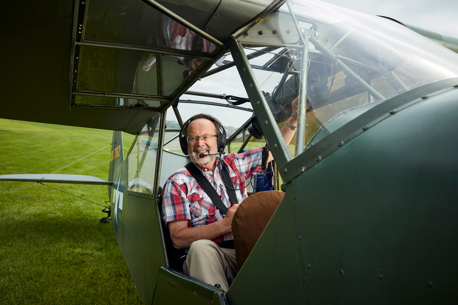 location portrait photography: pilot at control of airplane